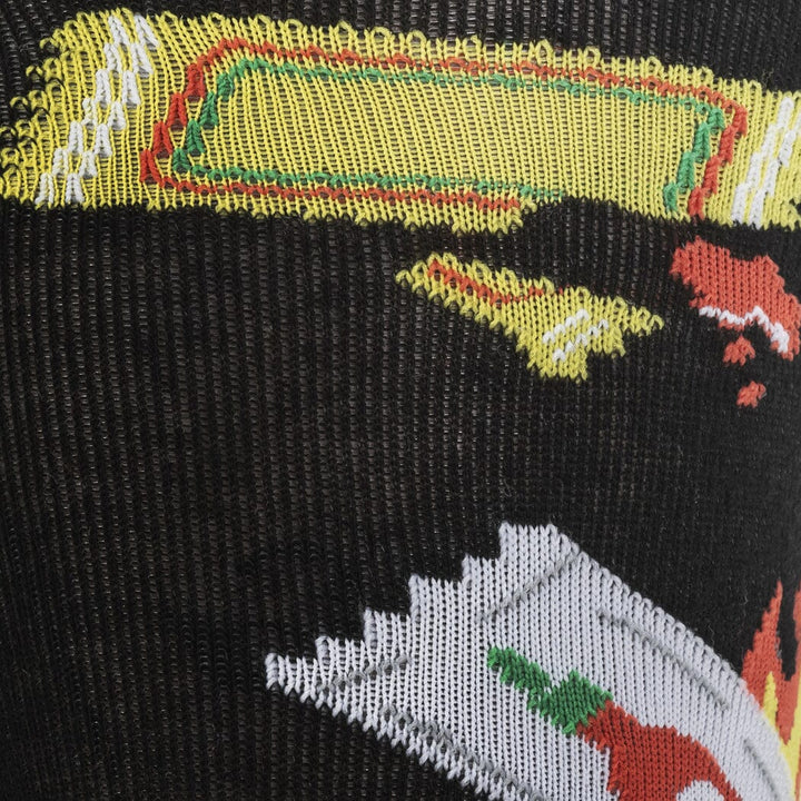 Close-up of a yellow sauce packet and a red-and-white HOT packet on the black knit