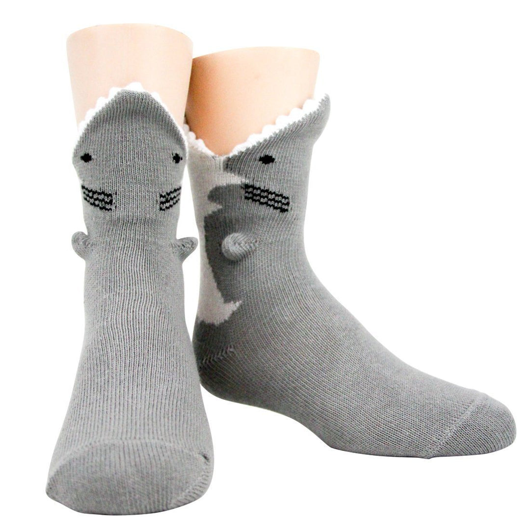 Kids' gray crew socks on foot forms with a 3D shark head, white toothy grin, and raised fin at the cuff