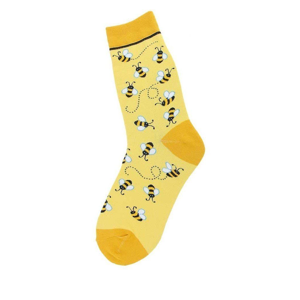 Women's yellow crew sock covered in little black-and-white bumble bees with dotted flight trails; golden toe, heel, and cuff.