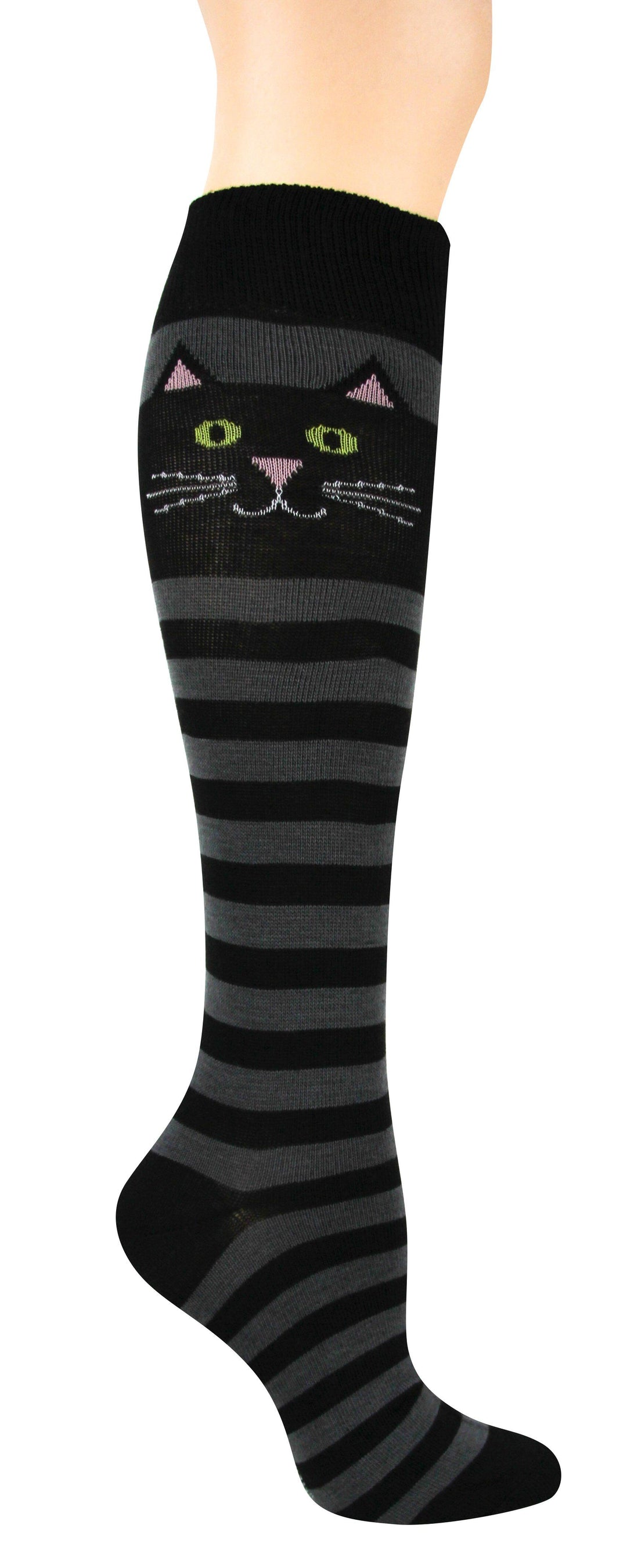 Women's black and gray striped cat knee-high sock shown on a leg, with a green-eyed cat face near the top of the calf