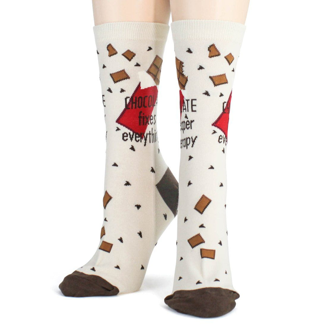 Back view of the worn chocolate socks featuring the "fixes everything!" wrapper and falling cocoa bars