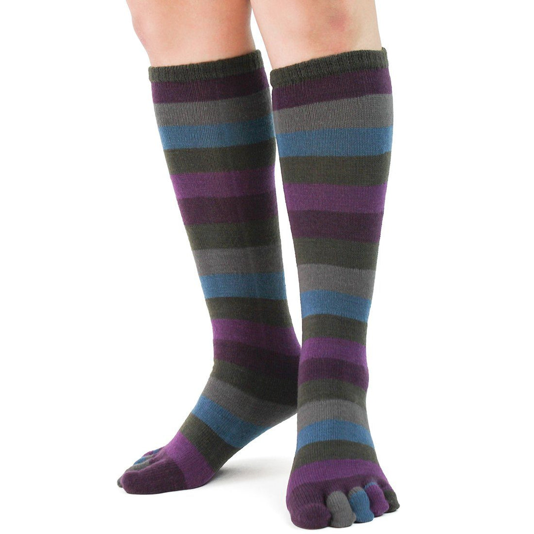 Back view of the striped knee high toe socks worn, showing the colorful leg stripes