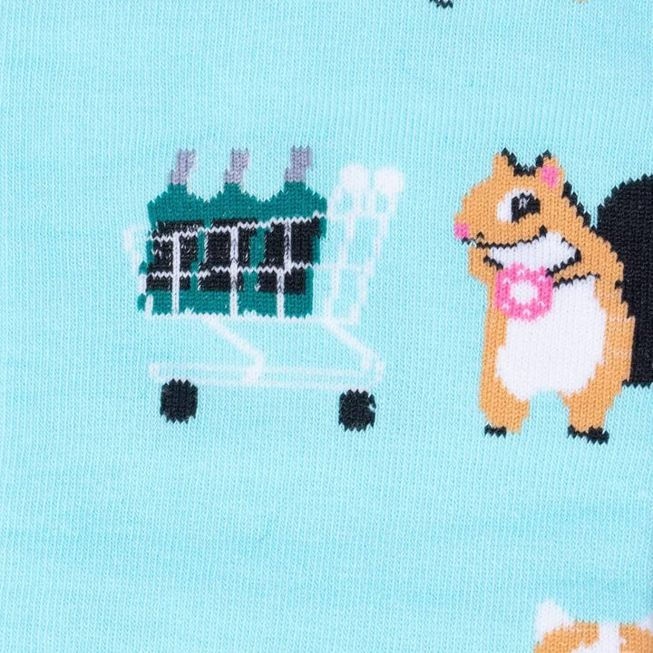 Close-up of a squirrel beside a green shopping cart full of bottles on the aqua sock