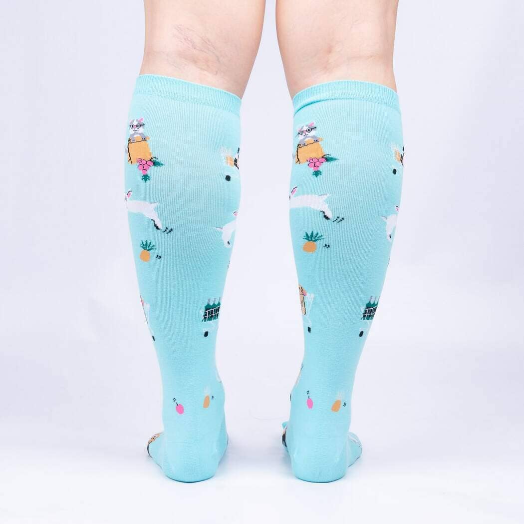 Back view of the aqua knee highs worn on legs, showing the bunnies, carts and pineapples