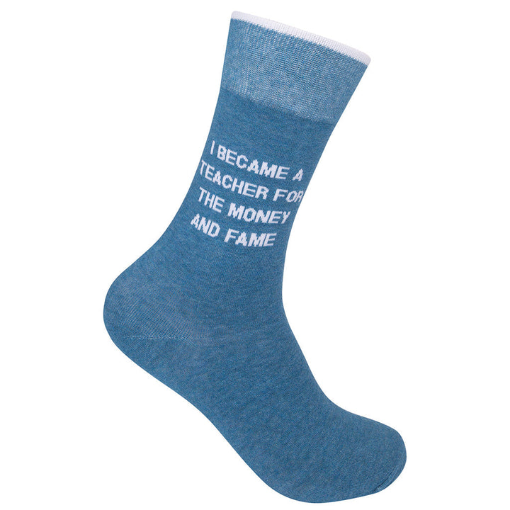 Blue crew sock reading I Became A Teacher For The Money And Fame in white text