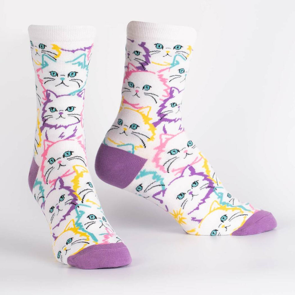 Pair of neon pop-art cat crew socks on display, showing colorful cat faces