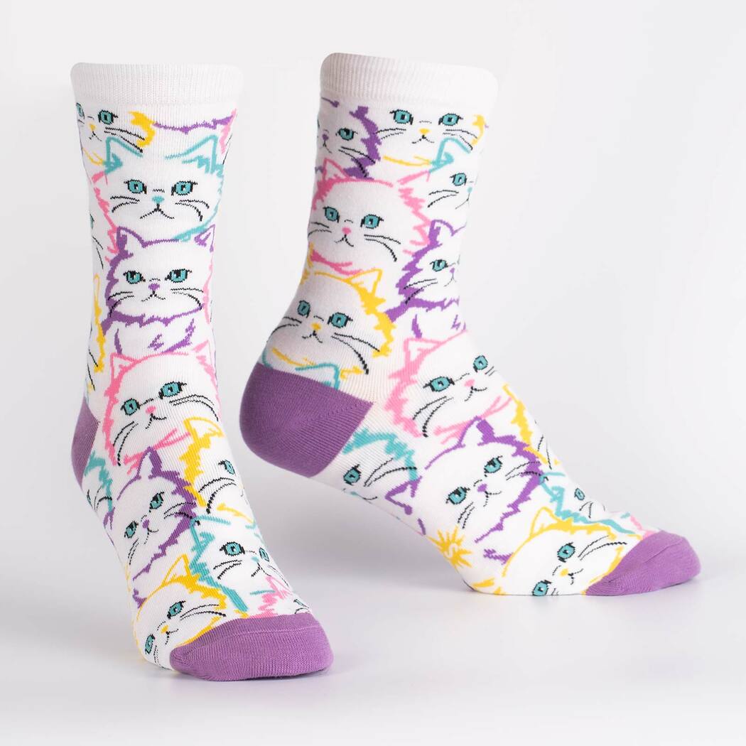 Pair of neon pop-art cat crew socks on display, showing colorful cat faces
