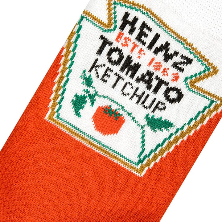 Close-up knit detail of the Heinz Tomato Ketchup label with the tomato graphic