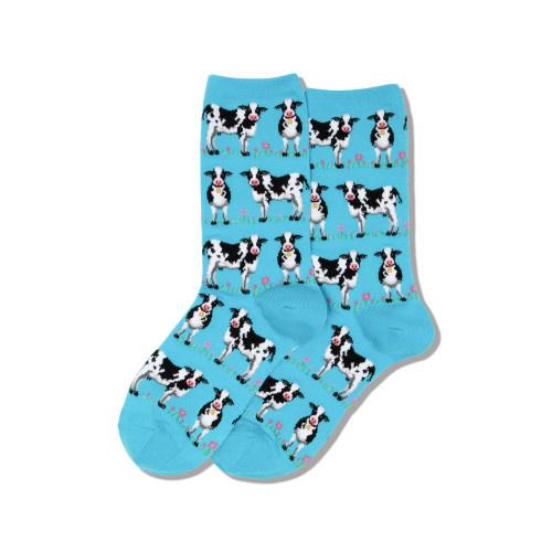 Women's sky-blue crew socks shown flat with rows of black-and-white cows and tiny pink flowers, blue heels and toes