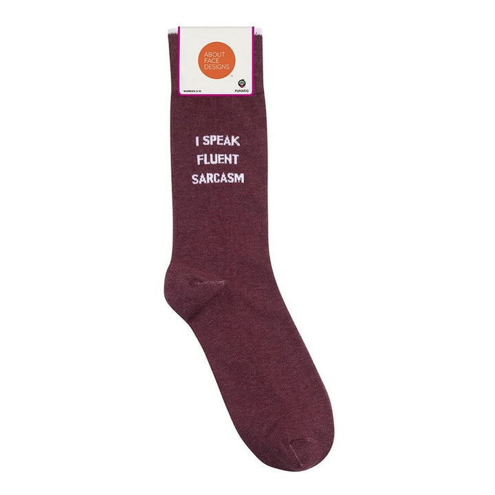 Flat burgundy sarcasm sock with About Face Designs packaging label at the cuff