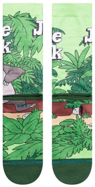Side leg detail of the Jungle Book socks with dense green palms and partial title lettering