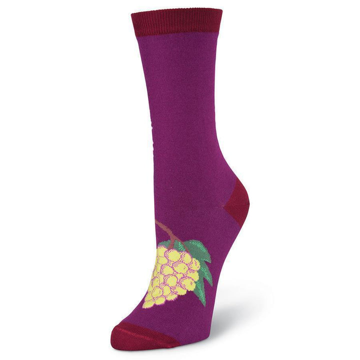 Foot detail of the Drink Wine crew sock highlighting the golden grape cluster with green leaves on berry purple