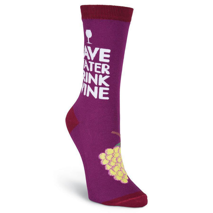 Front-angled view of the Drink Wine crew sock showing the slogan and a cluster of golden grapes on the foot