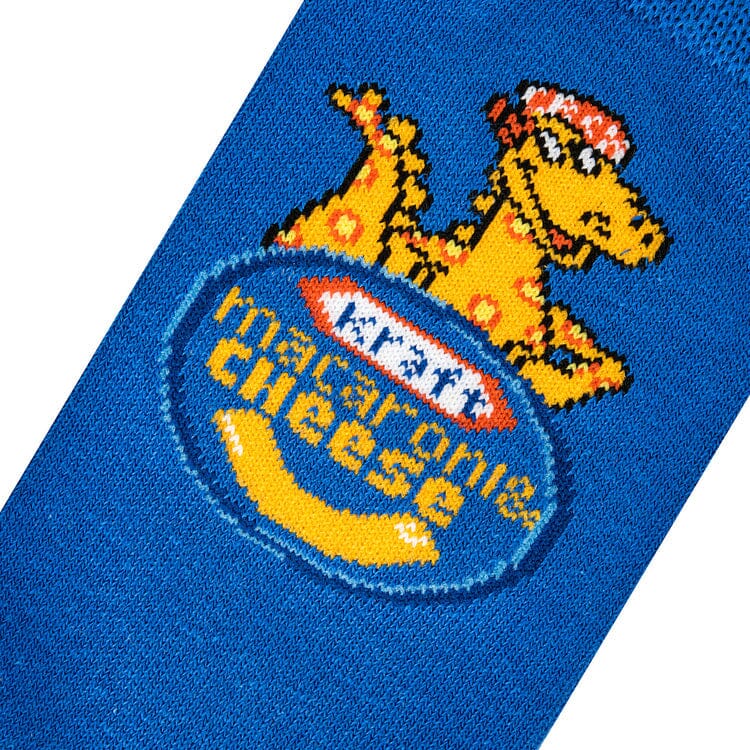 Close-up knit detail of the noodle dinosaur mascot above the Kraft Macaroni &amp; Cheese logo
