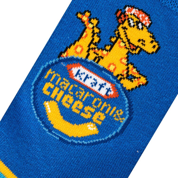 Close-up knit detail of the noodle dinosaur mascot above the Kraft Macaroni &amp; Cheese logo