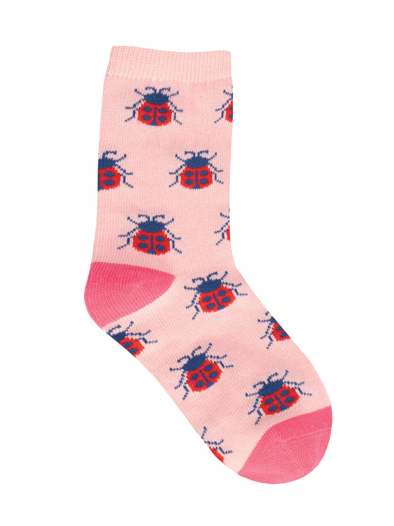 Single kids' blush pink crew sock with red and blue ladybugs, with coral-pink heel and toe