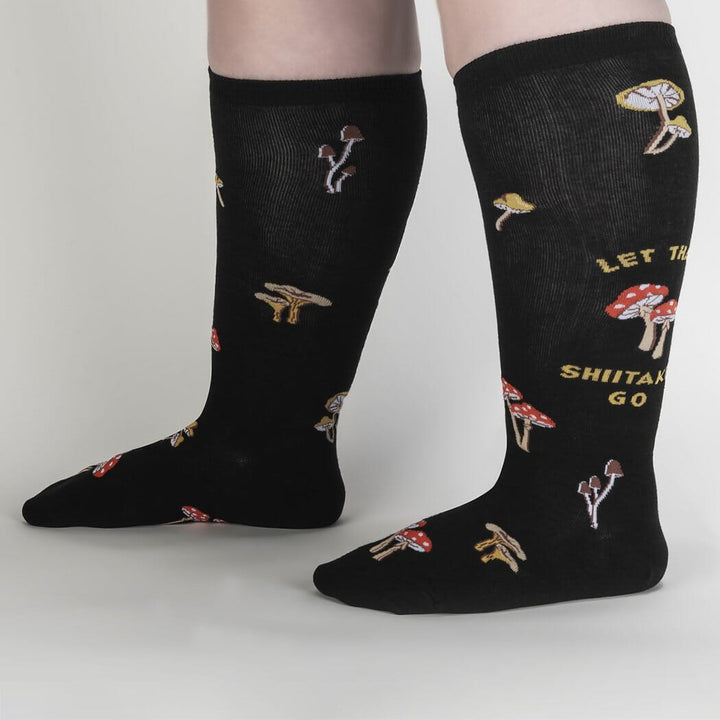 Second side view of the black mushroom knee high socks worn on a model&