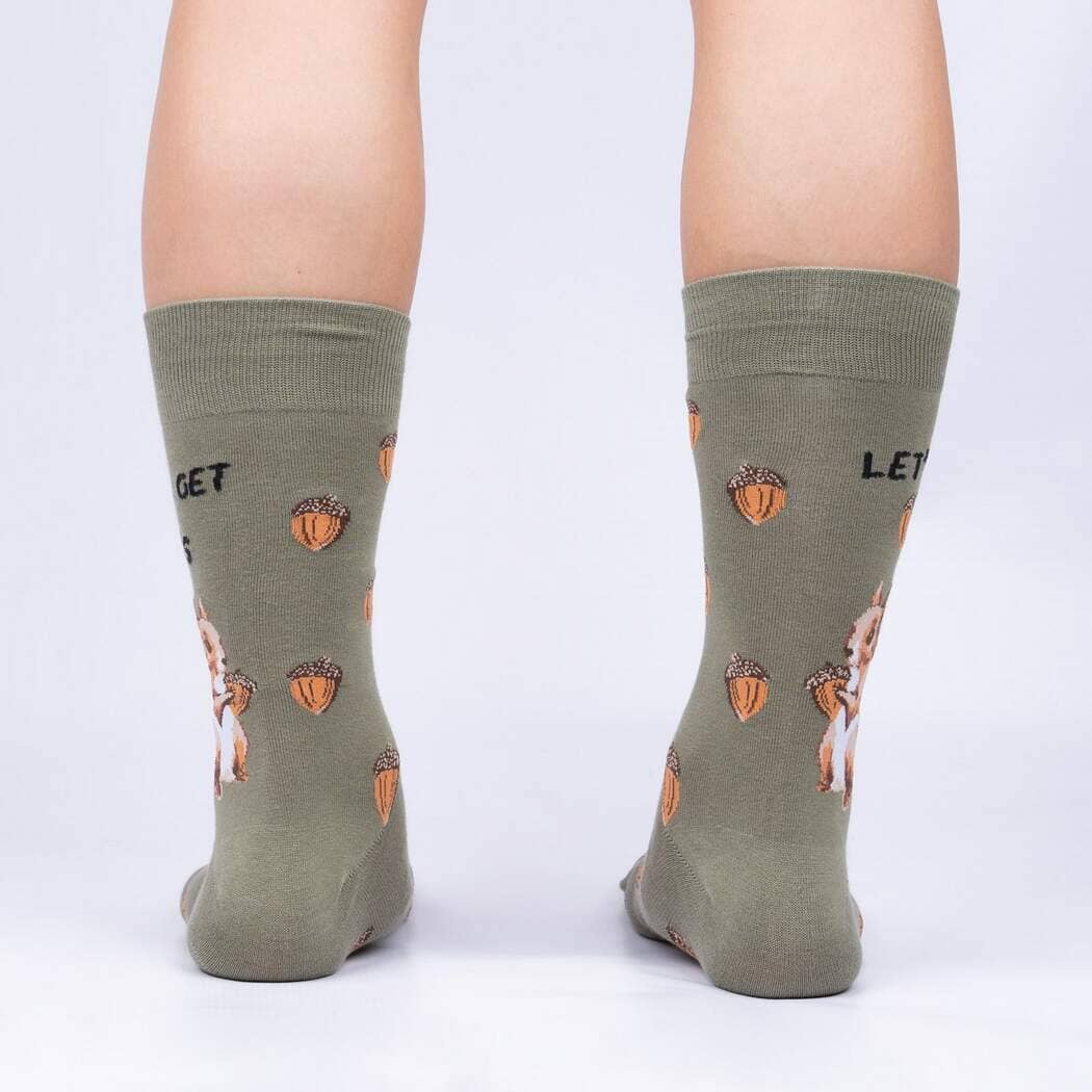 Back view of the olive socks worn on legs, showing acorns and squirrels wrapping around