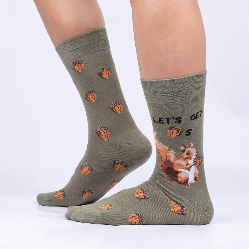Side view of the squirrel socks worn on legs, showing the squirrel and acorn pattern