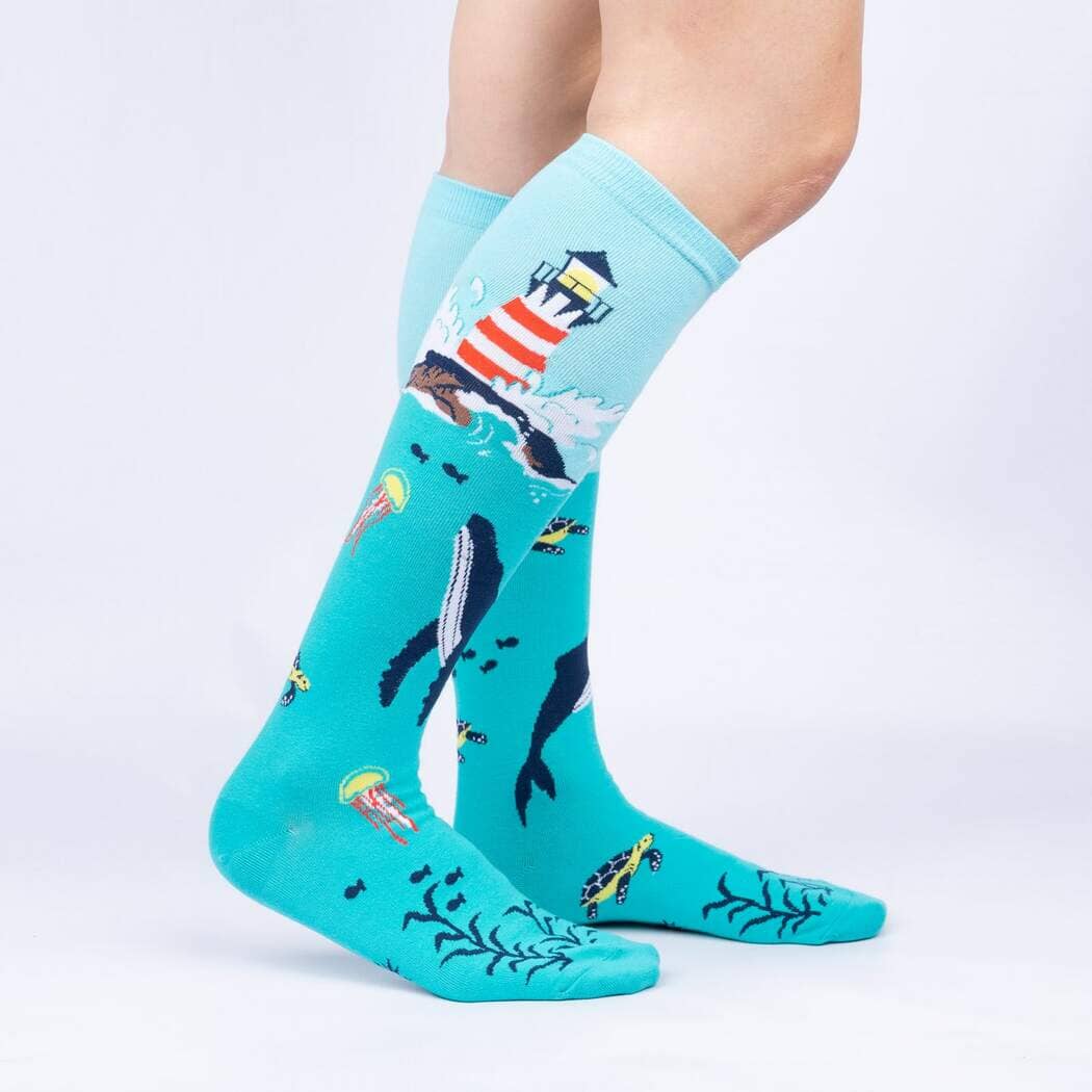 Side view of the lighthouse knee highs worn on legs, showing the whale and underwater life