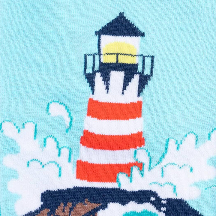 Close-up of the sock detail showing the red-and-white striped lighthouse with crashing waves