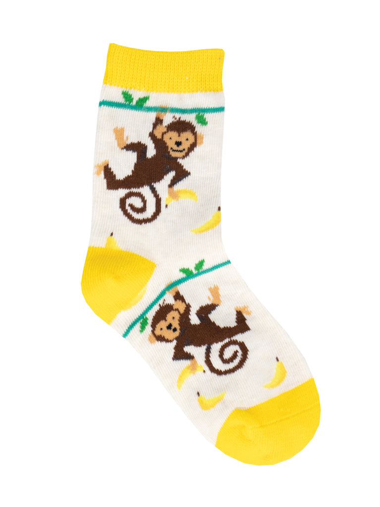 Single kids' cream crew sock with brown monkeys swinging from vines reaching for bananas, with yellow cuff, heel, and toe