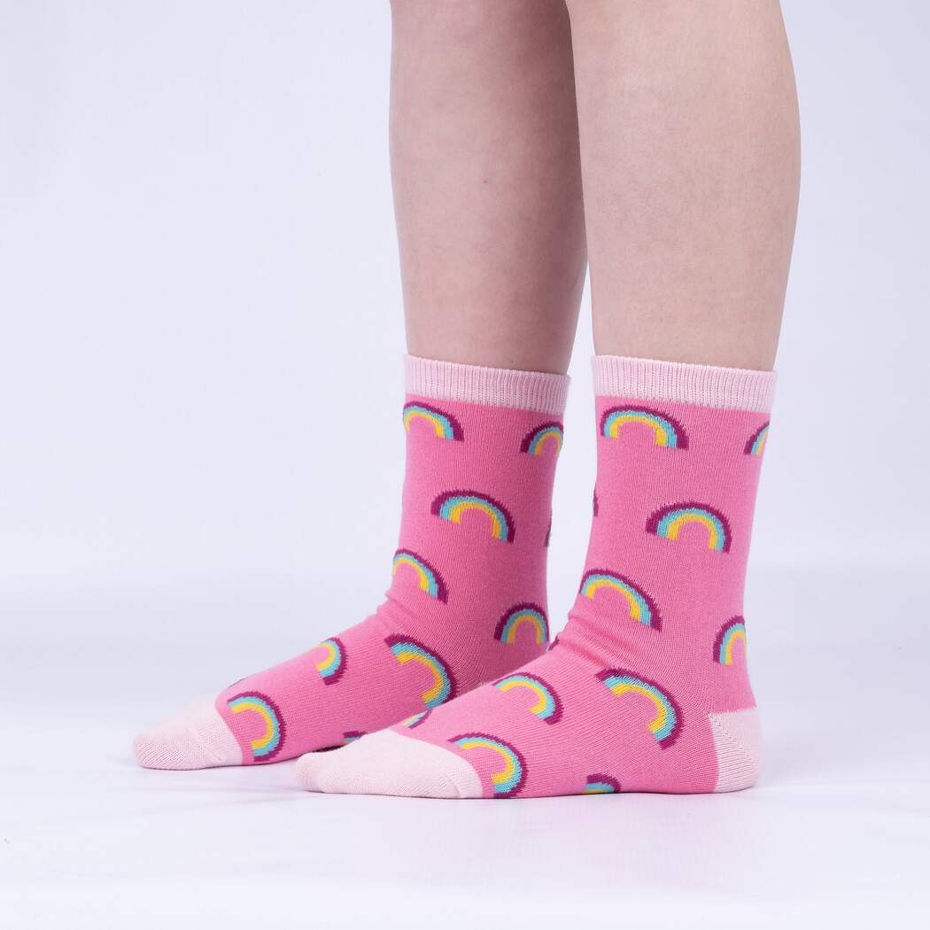 Child wearing the pink rainbow print junior crew socks, side view