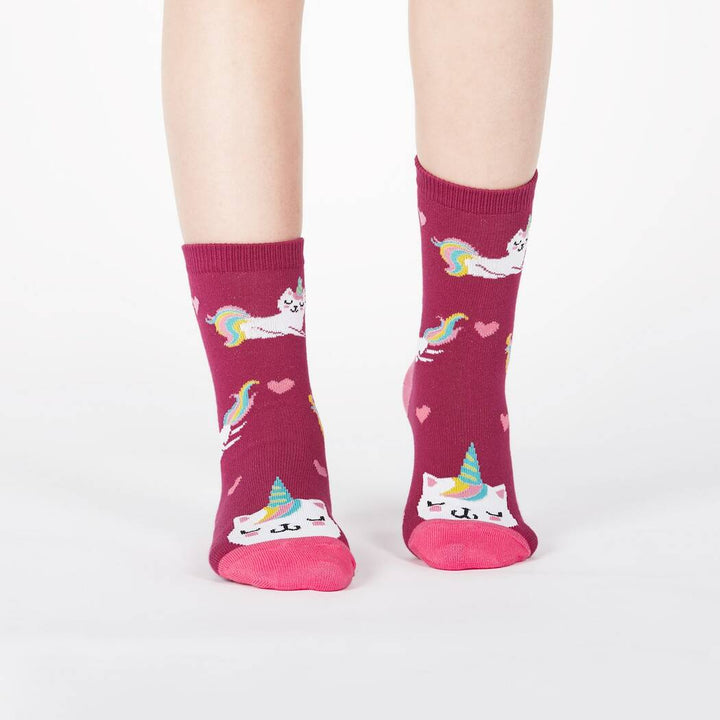 Child wearing the berry pink unicorn cat junior crew socks, front view