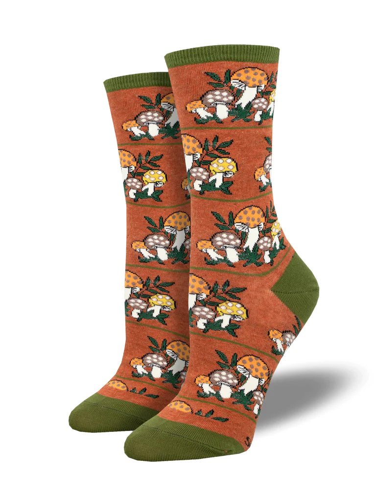 Women's rust crew socks patterned with bearded gnomes and mushrooms, with olive green cuff, heel, and toe