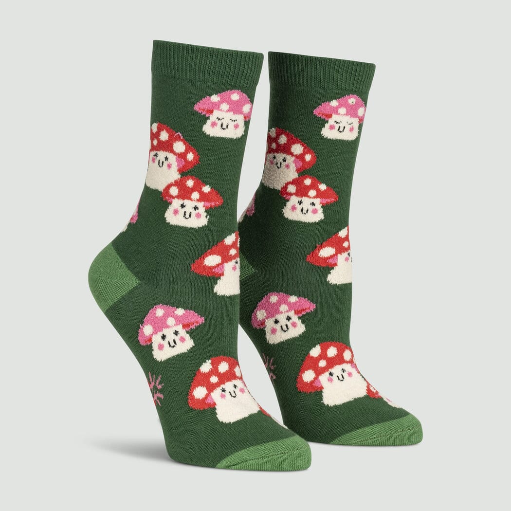 Women's mellow mushroom crew socks in forest green, flat lay showing fuzzy blushing toadstool faces