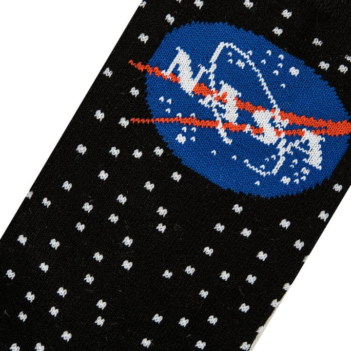 Close-up knit detail of the blue NASA meatball logo with its red swoosh on a starry background