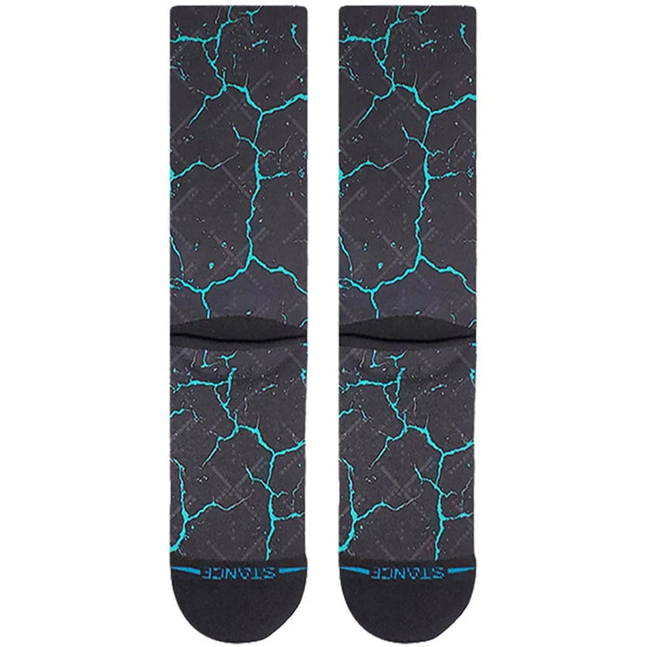 Detail view of the black socks showing the glowing teal crack texture and Stance branding