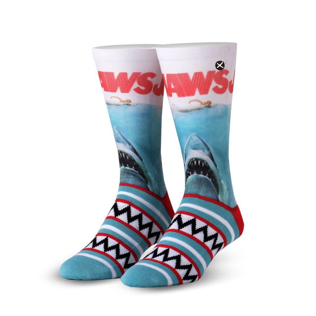 Men's Jaws crew socks displayed as a pair showing the great white shark poster art, red 'Jaws' title, and striped aqua and red foot