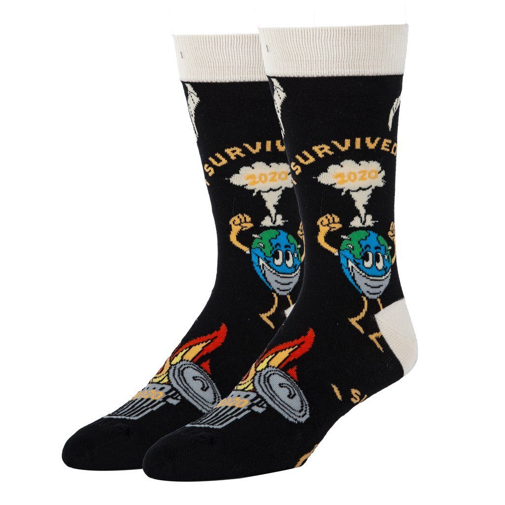 Men's I Survived 2020 crew socks shown as a pair, front view, with a masked flexing Earth, mushroom cloud and toilet paper on black