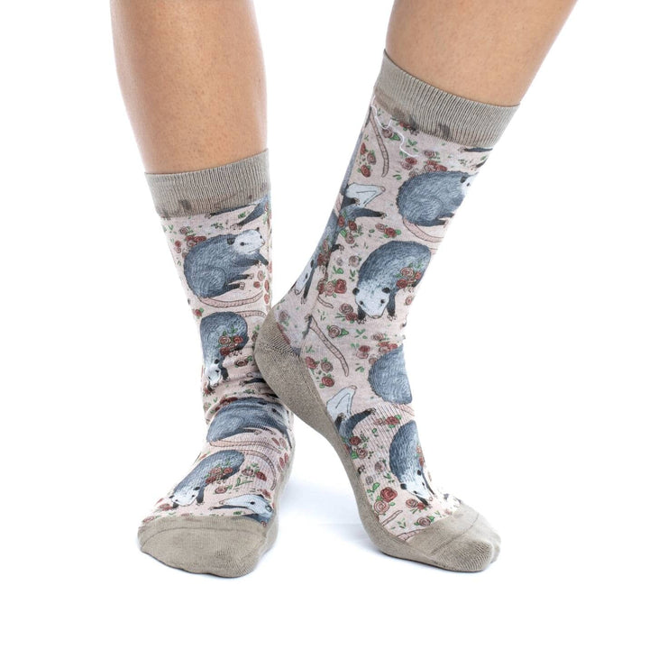 Opossum and roses crew socks worn on a model&