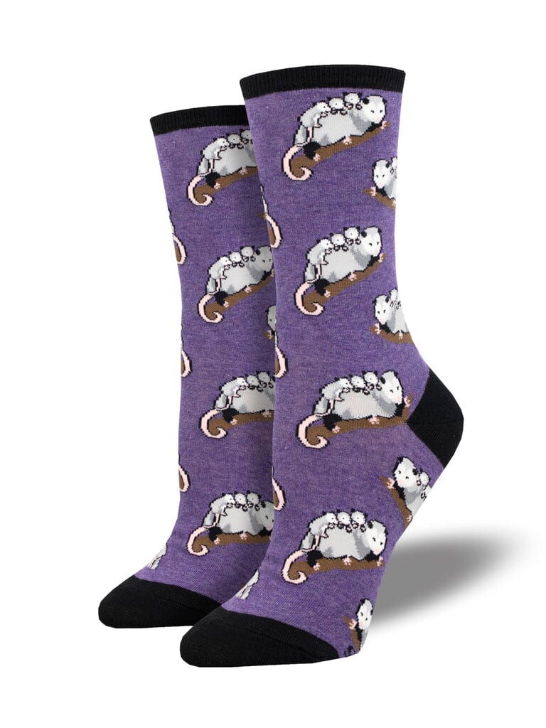 Women's opossum posse crew socks in purple with opossums on tree branches, flat product shot