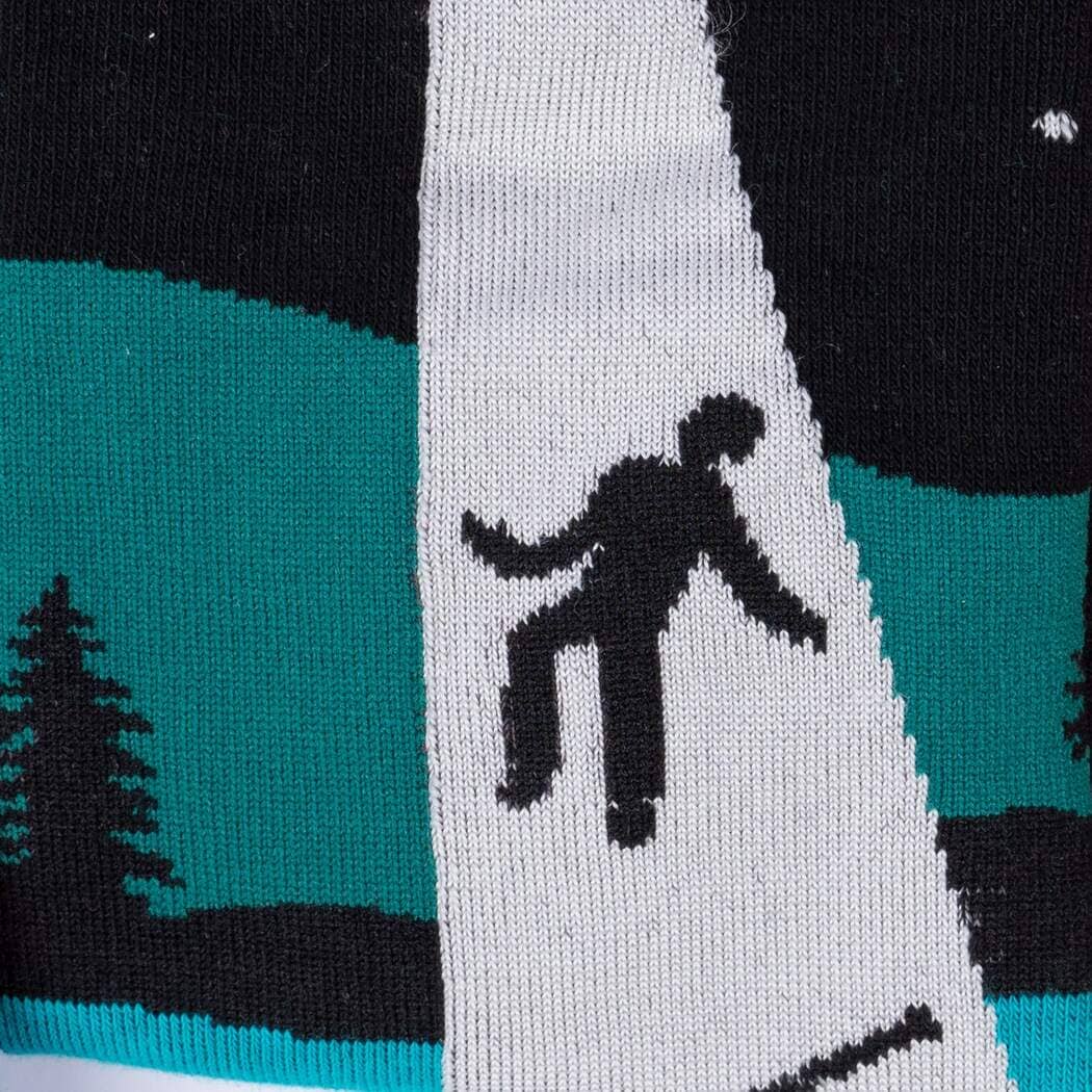 Close-up of the sock detail showing the UFO tractor beam lifting a tiny figure from a canoe