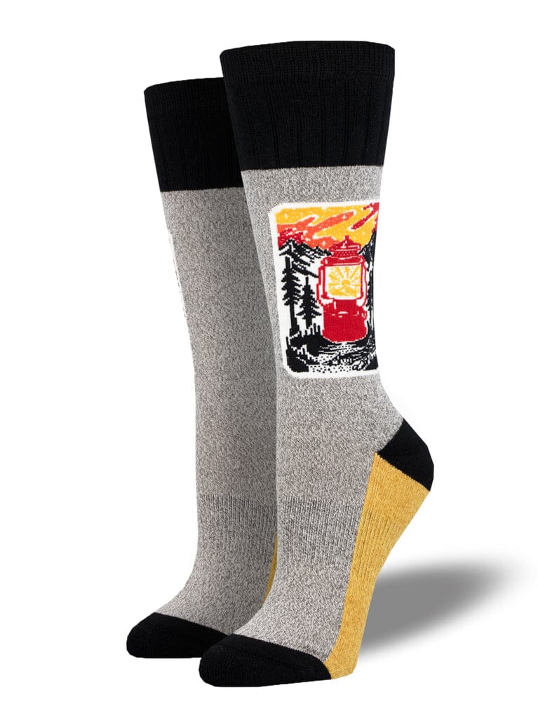 Women's light my fire crew socks, flat lay showing a red camp lantern and pine trees patch on heathered gray