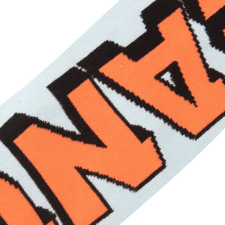 Close-up knit detail of the bold orange and black Peanuts logo on light blue