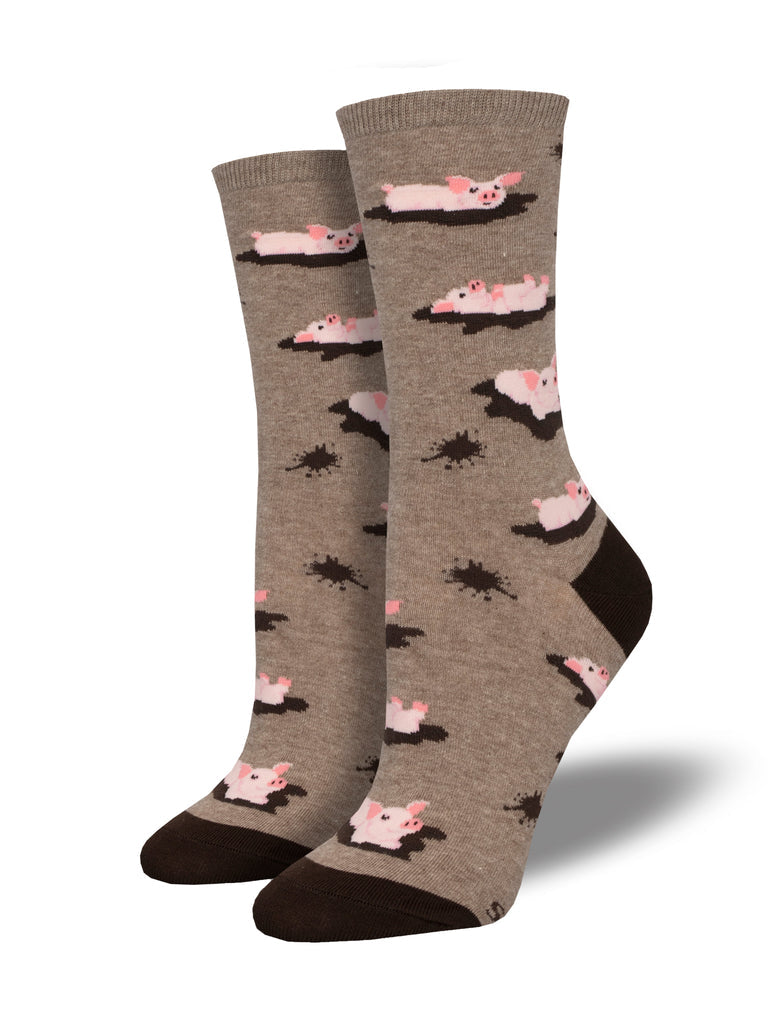 Pair of women's heathered tan crew socks with pink pigs lounging in brown mud puddles and brown heels and toes