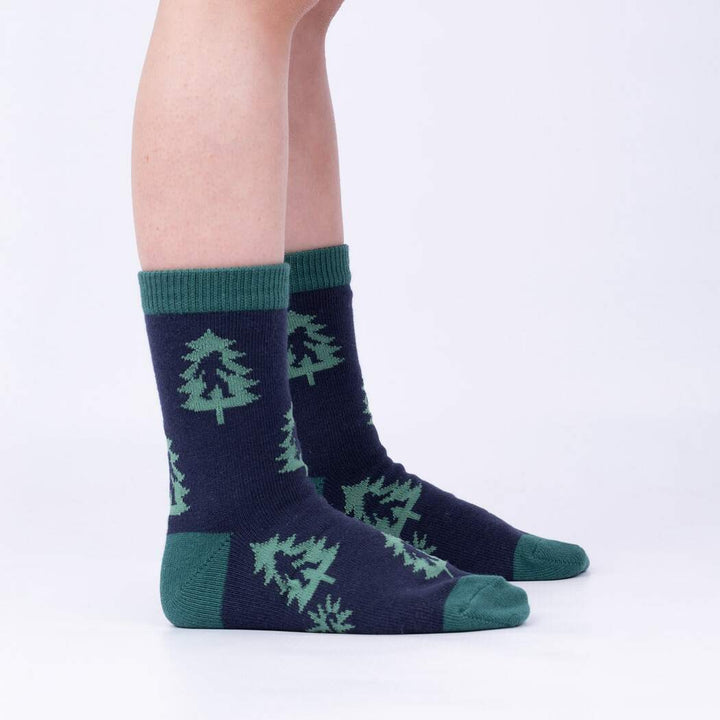 Child wearing the navy and green pine tree junior crew socks, side view