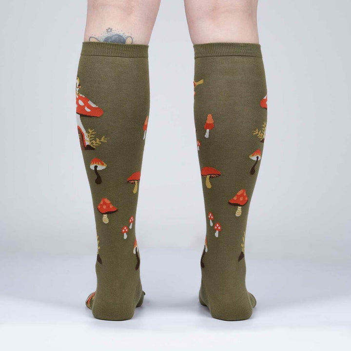 Back view of the woodland mushroom knee high socks worn, showing scattered mushrooms