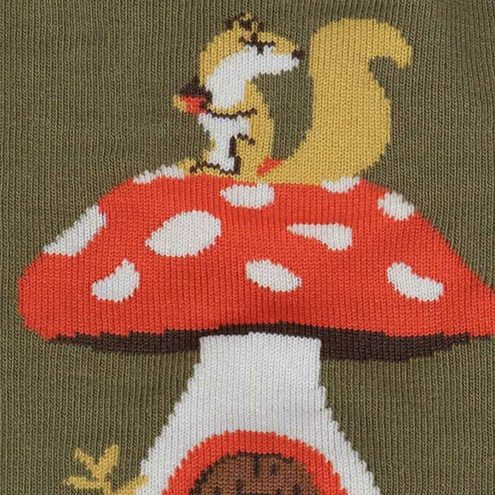 Close-up of the toadstool mushroom house with a squirrel perched on top