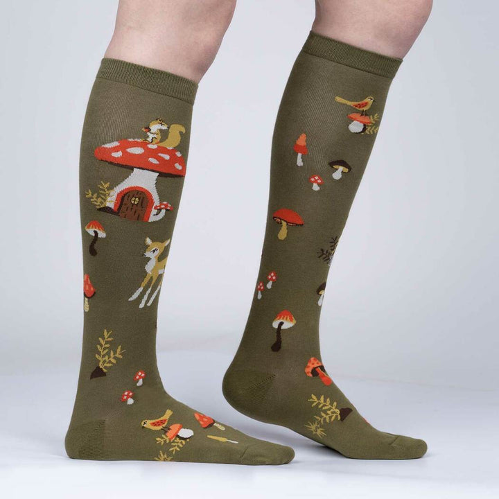 Side view of the woodland knee high socks worn, showing the mushroom house and fawn