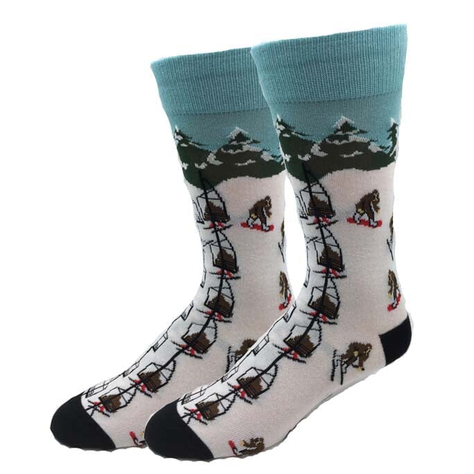 Men's Skiing Bigfoot crew socks, flat front view with Sasquatch skiing down a snowy mountain run