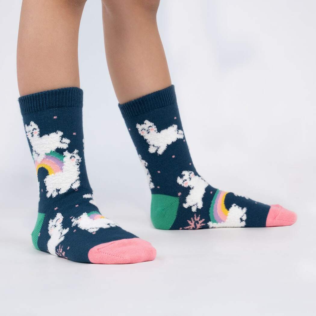 Side view of child wearing the navy alpaca-and-rainbow crew socks with pink toes