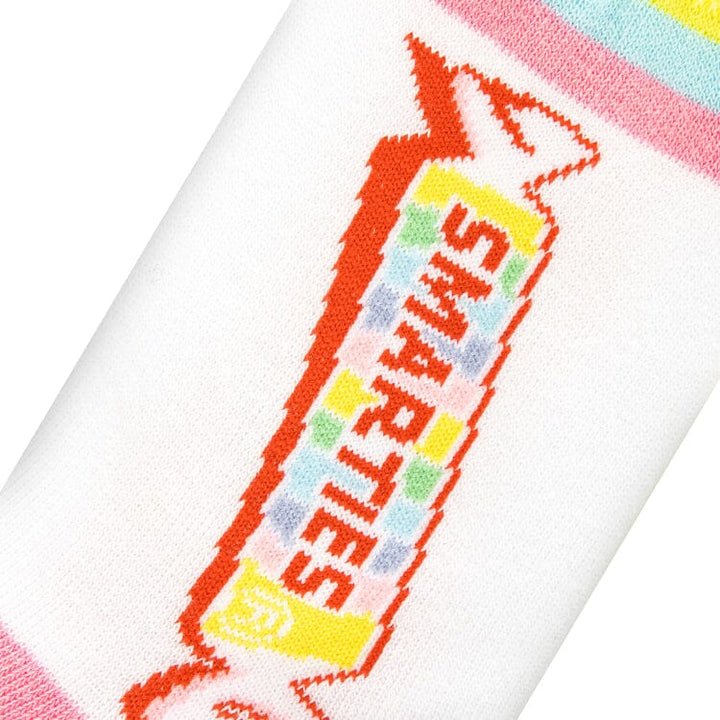 Close-up knit detail of the colorful Smarties candy wrapper with rainbow lettering