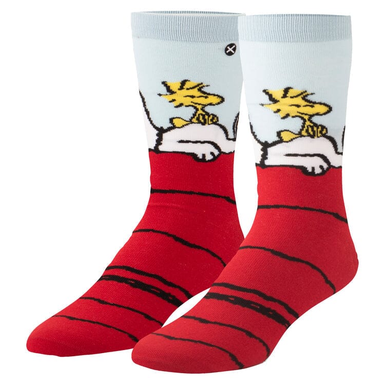 Men's crew socks with a light blue cuff showing Snoopy lying on his red doghouse with Woodstock on his belly
