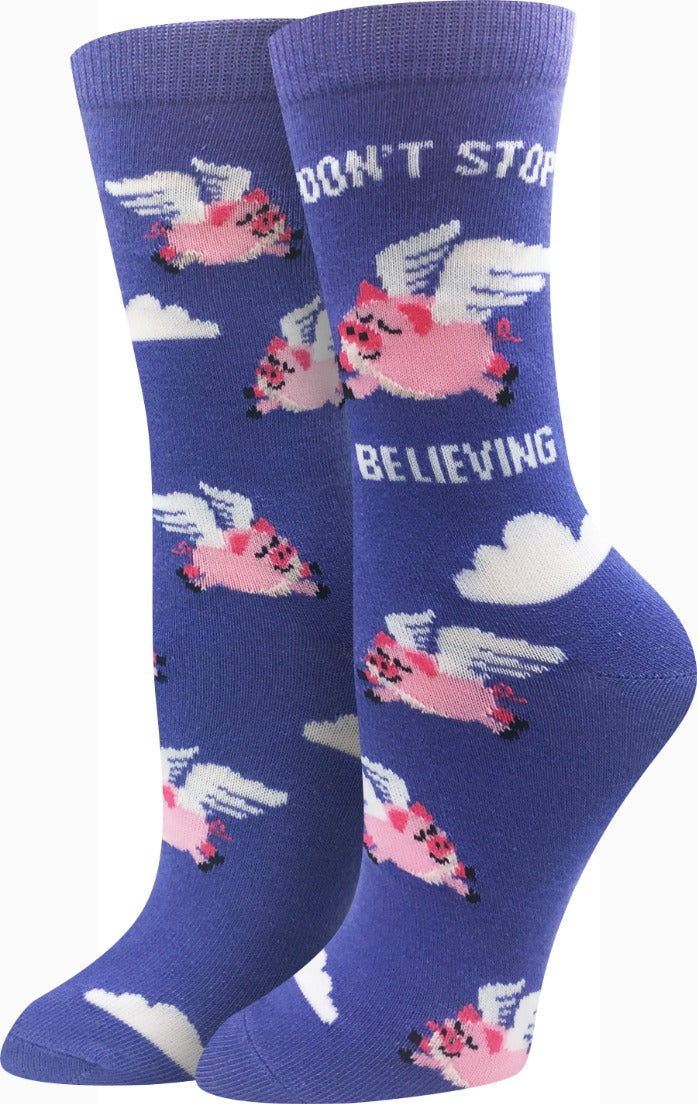 Periwinkle women's crew socks with winged pink pigs, clouds, and the words Don't Stop Believing