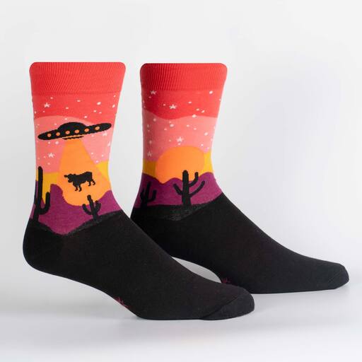 Men's Area 51 alien crew socks shown on foot forms with sunset sky, UFO abducting a cow, and black foot
